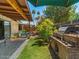 Enjoy the backyard with a built-in BBQ, lush lawn, mature trees and a comfortable porch swing at 5517 W Commonwealth Pl, Chandler, AZ 85226