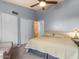 Bright bedroom features two closets, a ceiling fan, a window, and a cozy armchair at 5517 W Commonwealth Pl, Chandler, AZ 85226