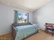 Spare bedroom featuring a trundle bed, desk, large window, and neutral decor at 5517 W Commonwealth Pl, Chandler, AZ 85226