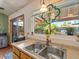 Kitchen sink featuring a double basin, window with stained glass, and a view to the backyard at 5517 W Commonwealth Pl, Chandler, AZ 85226
