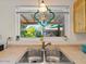 Kitchen sink featuring a double basin, window with stained glass, and a view to the backyard at 5517 W Commonwealth Pl, Chandler, AZ 85226