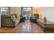 Comfortable living room featuring a large sectional couch and beautiful tile flooring at 5517 W Commonwealth Pl, Chandler, AZ 85226