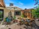 Charming backyard patio with outdoor dining set, porch swing, and ample space for entertaining guests at 5517 W Commonwealth Pl, Chandler, AZ 85226