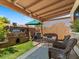 Outdoor patio area with BBQ, seating, privacy shade, and green yard at 5517 W Commonwealth Pl, Chandler, AZ 85226