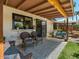 Outdoor patio with seating, overhead shelter, and lush landscaping at 5517 W Commonwealth Pl, Chandler, AZ 85226