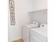 Practical laundry room equipped with modern washing and drying machines and shelving at 5834 S Daisy Patch Pl, Phoenix, AZ 85040