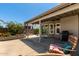 Covered patio with outdoor seating provides a relaxing space in the landscaped backyard, perfect for entertaining at 6018 W Villa Maria Dr, Glendale, AZ 85308