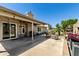 Spacious covered patio with a view of the beautifully landscaped backyard oasis, featuring a fountain and seating area at 6018 W Villa Maria Dr, Glendale, AZ 85308