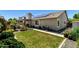 Well-maintained backyard with lush green grass, mature landscaping, and a charming patio area with room to relax at 6018 W Villa Maria Dr, Glendale, AZ 85308