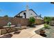 Private backyard with a quaint seating area, mature landscaping, and a charming brick-lined planter for added character at 6018 W Villa Maria Dr, Glendale, AZ 85308