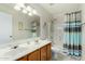 Bright bathroom featuring double sinks and a shower-tub combination at 6018 W Villa Maria Dr, Glendale, AZ 85308