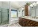 Bright bathroom featuring double sinks, a bathtub, and a glass-enclosed shower at 6018 W Villa Maria Dr, Glendale, AZ 85308