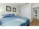 Cozy bedroom featuring framed artwork, blue bedding, and closet at 6018 W Villa Maria Dr, Glendale, AZ 85308