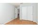 Bedroom with closet, door to bathroom, and wood laminate flooring at 6018 W Villa Maria Dr, Glendale, AZ 85308