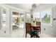Bright breakfast nook featuring a charming table, white shutters, and easy access to the backyard through sliding glass doors at 6018 W Villa Maria Dr, Glendale, AZ 85308