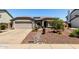 Charming single-story home featuring desert landscaping, a two-car garage, and solar panels at 6018 W Villa Maria Dr, Glendale, AZ 85308
