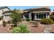 Charming single-story home boasts a desert landscaped yard with low-water plants and a neutral color scheme at 6018 W Villa Maria Dr, Glendale, AZ 85308