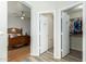 Hallway view to a Primary bedroom and walk-in closet with organized clothing at 6018 W Villa Maria Dr, Glendale, AZ 85308