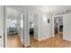Hallway with an opening to a room and wood laminate flooring at 6018 W Villa Maria Dr, Glendale, AZ 85308