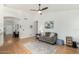 Bright living room boasts hardwood floors, a gray sofa, and a view of the entry at 6018 W Villa Maria Dr, Glendale, AZ 85308