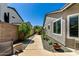 Well-maintained side yard featuring a walkway lined with lush plants, providing a serene and inviting outdoor space at 6018 W Villa Maria Dr, Glendale, AZ 85308