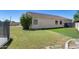 The backyard has a privacy wall, lush green grass, and mature trees at 6742 W El Cortez Pl, Peoria, AZ 85383