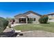 Spacious backyard with lush grass, an outdoor kitchen and covered patio area at 6742 W El Cortez Pl, Peoria, AZ 85383