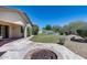 Well-maintained yard features a cozy firepit, lush lawn and pool area at 6742 W El Cortez Pl, Peoria, AZ 85383