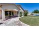 Backyard features a covered patio that leads to a grassy lawn and swimming pool at 6742 W El Cortez Pl, Peoria, AZ 85383