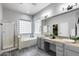 Bright bathroom featuring a large soaking tub, a glass-enclosed shower, and dual sinks at 6742 W El Cortez Pl, Peoria, AZ 85383