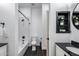 Full bathroom with black tiled floor and white subway tiled shower at 6742 W El Cortez Pl, Peoria, AZ 85383