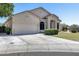 Traditional-style home featuring a two-car garage and manicured front yard landscaping at 6742 W El Cortez Pl, Peoria, AZ 85383