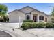 Charming single-Gathering home with a well-manicured lawn, garage, and covered entryway at 6742 W El Cortez Pl, Peoria, AZ 85383