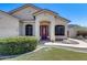 Inviting front exterior with arched entry, desert landscaping, and a burgundy front door at 6742 W El Cortez Pl, Peoria, AZ 85383