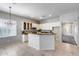 Sunlit kitchen with a convenient center island, perfect for meal prep and casual dining at 6742 W El Cortez Pl, Peoria, AZ 85383