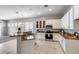 Bright kitchen with white cabinetry, stainless appliances, and a functional center island at 6742 W El Cortez Pl, Peoria, AZ 85383