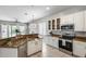 Well-lit kitchen featuring white cabinets, stainless steel appliances, and stylish countertops at 6742 W El Cortez Pl, Peoria, AZ 85383