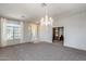 Spacious living area with carpeting and a view into a study area with built-ins at 6742 W El Cortez Pl, Peoria, AZ 85383