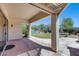 A covered patio with a stamped concrete floor overlooks a green lawn at 6742 W El Cortez Pl, Peoria, AZ 85383
