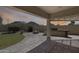Covered patio with a built-in grill, outdoor kitchen, and desert landscaping at 6742 W El Cortez Pl, Peoria, AZ 85383