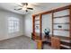 Cozy study with built-in shelves, neutral walls, and a ceiling fan at 6742 W El Cortez Pl, Peoria, AZ 85383