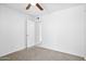 This is a bedroom with white walls and carpet. It has a ceiling fan and two light switches at 7110 E Continental Dr # 2008, Scottsdale, AZ 85257