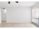 Bright, empty living room features tile flooring, a ceiling fan, and sliding glass doors leading to a balcony at 7110 E Continental Dr # 2008, Scottsdale, AZ 85257