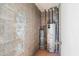 The utility room shows the hot water heater, exposed pipes, and storage space at 7110 E Continental Dr # 2008, Scottsdale, AZ 85257