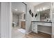 A well-lit bathroom with a vanity, stylish mirror, and adjacent toilet area for enhanced functionality at 7220 E Edgewood Ave, Mesa, AZ 85208