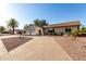 Expansive home exterior showcasing desert landscaping, a two-car garage, and an extended driveway at 7220 E Edgewood Ave, Mesa, AZ 85208
