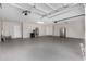 Spacious garage with ample parking space, stainless refrigerator, and fresh epoxy flooring at 7220 E Edgewood Ave, Mesa, AZ 85208