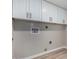 White cabinets and fresh paint make this laundry room renovation move-in ready at 7220 E Edgewood Ave, Mesa, AZ 85208