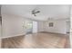 Spacious open concept living room with wood-look floors and a sliding glass door at 7220 E Edgewood Ave, Mesa, AZ 85208