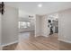A bright living room space flows into a modern kitchen featuring stainless steel appliances and light wood floors at 7220 E Edgewood Ave, Mesa, AZ 85208